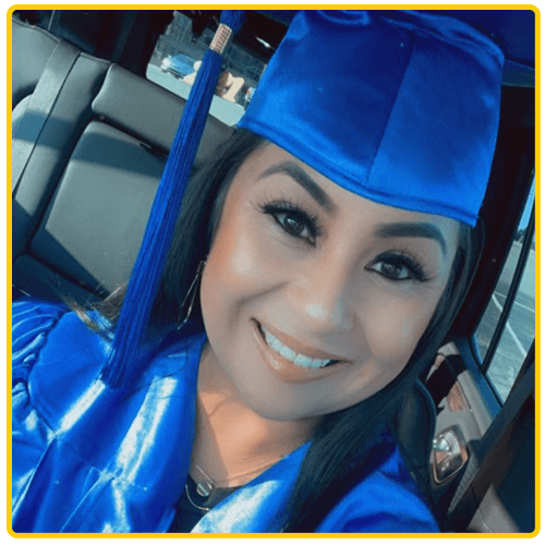 Hispanic woman with graduation cap in her car