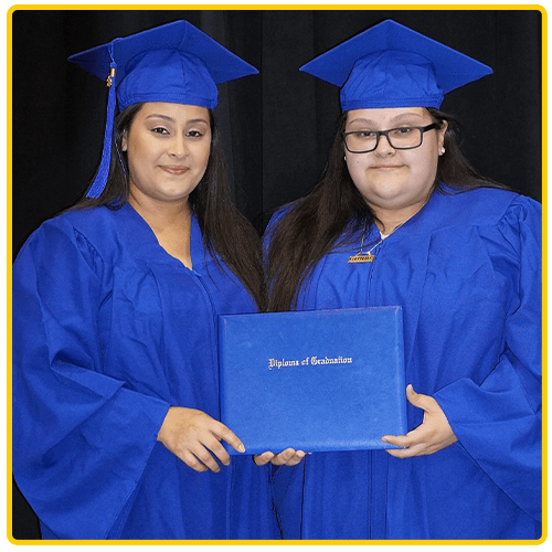 2 girls in blue gowns with diploma
